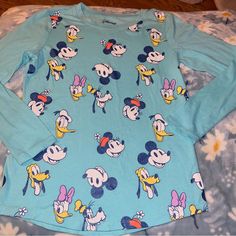 a blue shirt with mickey mouses on it