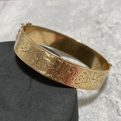 About the item: Gorgeous bangle- 1/5 9ct gold over bronze core. Measures internal diameter of 5.5cm. Signed AJ. In good condition, with a light patina, which could easily be polished to a high shine, should you wish to do so. Display box/stand not included. P&P includes postage, packaging and all related costs. Most items are sent tracked and signed for, where available/appropriate. Golden Bracelet For Women Indian, Gold Bracelet With Decorative Band As Gift, Gold Bracelets With Decorative Band As Gift, Classic Gold Etched Bangle, Gold Bracelet With Decorative Band For Anniversary, Antique Gold Bangle With Jubilee Bracelet, Heirloom Gold Hinged Bracelets, Ornate Gold Etched Bangle, Heirloom Gold Hinged Bracelet