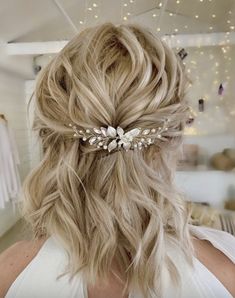 a woman with blonde hair wearing a bridal headpiece