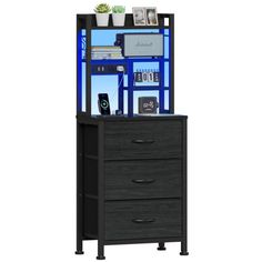 a tall black cabinet with drawers underneath it