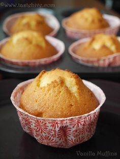 several muffins sitting in paper cups on a tray