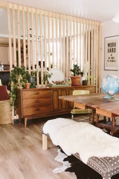 a living room filled with furniture and a wooden table topped with a cowhide rug