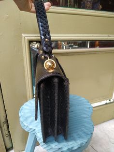 "Welcome! Vintage from the 1950s Lovely, luxurious black snakeskin handbag with a fabulous gold clasp. The inside is suede leather and has a pocket with zipper and two small pockets more. This bag is in very good condition! Dimensions: - W: 9.84\" (25 cm) - H: 7.87\" (20 cm) - Deep: 7.99\"(20.30 cm) - Handles: 16.14\" (41 cm) Thanks for stoppingby!IMPORTANT: Due to the delicate situation We're all going through, and in order to keep the safety of courier workers too, all orders will be dispatche Leather Evening Bag With Gold Clasp, Evening Leather Bag With Gold Clasp, Formal Leather Bag With Gold Clasp, Vintage Textured Leather Evening Bag, Vintage Evening Shoulder Bag With Gold-tone Hardware, Vintage Gold Shoulder Bag For Business, Vintage Shoulder Bag With Brass Hardware For Evening, Snake Skin Handbag, Spain Fashion