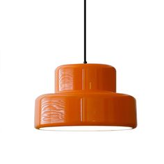 an orange pendant light hanging from a ceiling