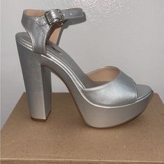 Gorgeous Silver Heels. They Are Very Comfortable And Can Be Worn For Any Ocasin. Comes With Stick On The Heel Never Have Worn Them Only Tried On When I Bought Themselves They Are A Size 6.5 Silver Heels With Stacked Heel And Ankle Strap, Silver Platform Heels With Ankle Strap, Silver High Heel Block Heels With Stacked Heel, Silver High Block Heels With Stacked Heel, Silver Synthetic Heels With Wrapped Heel, Silver Block Heels With Stacked High Heel, Silver Stacked Heel For Night Out, Silver Heels With Stacked Heel And Round Toe, Party Heels With Ankle Strap And Deep Heel Cup