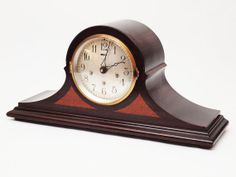 a small wooden clock sitting on top of a table