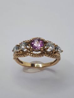 This stunning vintage style ring has been carefully crafted in warm 10k yellow gold, authentic Pink Tourmaline and authentic White Diamonds. Great for any occasion! Buy it for your-self or for someone you love! This beatiful ring will not go unnoticed. All of my jewellery is handmade from scratch and of high quality. A tracking shipping number will be provided to you once ring has been mailed. Ring is size 6 1/2 but can be resized at no extra cost and will be shipped to you in an elegant gift bo Vintage 14k Gold Sapphire Ring With Bezel Setting, Vintage Sapphire Ring With Bezel Setting In 14k Gold, Vintage 14k Gold Rings With Accent Stones, Vintage Yellow Gold Cluster Ring With Accent Stones, Vintage Gold Sapphire Ring With Accent Stones, Vintage Round Sapphire Ring With Accent Stones, Vintage 14k Gold Amethyst Ring With Accent Stones, Vintage Yellow Gold Ruby Ring With Accent Stones, Vintage Ruby Ring In Yellow Gold With Accent Stones