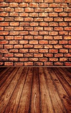 an old brick wall with wood flooring in the foreground and light shining on it