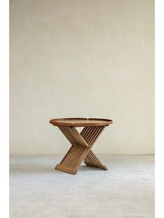 a wooden table sitting on top of a white floor