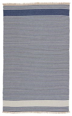 a blue and white striped rug with fringes