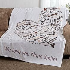 a couch with a blanket on it that says we love you nanna smith in many languages