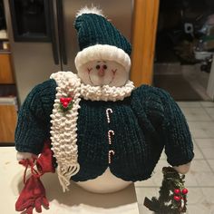 a snowman doll sitting on top of a counter