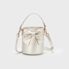 Introducing the Champagne Bucket Handbag - perfect for the sophisticated and stylish little lady in your life! This statement piece is sure to elevate any outfit, making it a must-have for any fashion-forward individual. Cheers to looking fabulous! Outside: 85% Polyurethane 15% Polyester Lining: 100% Polyester Luxury Formal Cream Bucket Bag, Luxury Cream Bucket Bag For Formal Occasions, Luxury Cream Formal Bucket Bag, Luxury Cream Bucket Bag For Evening, Toddler Girl Accessories, Neutral Accessories, Champagne Bucket, Bucket Handbags, Baby Boy Accessories