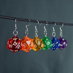 "These handmade D20 charm earrings are perfect for any TTRPG fan, cosplayer, or enthusiast! Length Charm: 2cm  Material: 925 sterling silver ear hooks/hoops Hoops: 20 or 10mm ♦️colors might be different due to light and angle♦️ Prio German shipping/Tracked shipping everywhere else Free Shipping on orders over 35€ worldwide with code \"ISHIPIT35\" !" D20 Earrings, Dice Earrings, D20 Dice, Ear Hook, Crafted Jewelry, Charm Earrings, Diy Jewellery, Star Fashion, Sterling Silber