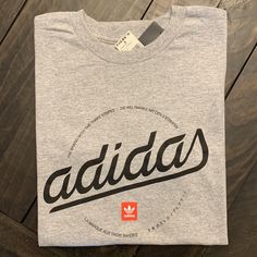 Heather Gray Adidas Scripted Short Sleeve T-Shirt. Crew Neck. Size Small. See Pictures For Measurements. 100% Cotton. Purchased From Tilly’s. Nwt! Spring Adidas Logo Relaxed Fit Tops, Spring Adidas Logo Top With Relaxed Fit, Adidas Crew Neck Shirt With Letter Print, Adidas Sporty Shirt With Letter Print, Adidas Graphic Tee For Streetwear, Adidas Gray Cotton Tops, Sporty Adidas Shirt With Letter Print, Adidas Logo Spring Crew Neck Top, Adidas Logo Crew Neck Top For Spring