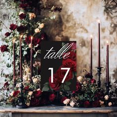 a table topped with candles and flowers next to a sign that says table 17 on it