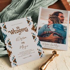 the wedding stationery is laid out on a table next to a key and photo