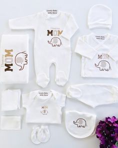 "Celebrate the boundless love between a baby and their mum with our Organic Cotton \"I Love My Mum\" Newborn Baby Set. Crafted with the utmost care and consideration for both your little one and the planet, this 10-piece bundle combines softness, sustainability, and heartfelt sentiment. Made from 100% organic cotton, these garments offer unparalleled comfort and coziness for your newborn's early days. Our commitment to organic living and eco-consciousness led us to create this exquisite baby set Customizable White Gift Sets, I Love My Mum, Newborn Coming Home Outfit, Personalized Newborn, Girls Coming Home Outfit, Knitted Baby Clothes, Newborn Sets, Organic Living, Organic Cotton Baby