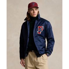 This lightweight layer unites a sporty silhouette with the iconic P-wing logo from Ralph Lauren’s 1992 Stadium collection. Sports Outerwear With Logo Patch For Fall, Fall Sports Outerwear With Logo Patch, Sporty Ralph Lauren Fall Outerwear, Spring Sporty Outerwear With Logo Patch, Spring Sporty Varsity Jacket For Outdoor, Sporty Spring Outerwear With Logo Patch, Sporty Spring Outerwear With Embroidered Logo, Spring Outdoor Sporty Varsity Jacket, Sporty Outerwear With Logo Patch For Sports