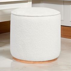 a white stool sitting on top of a kitchen floor