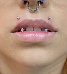 a woman with two piercings on her nose