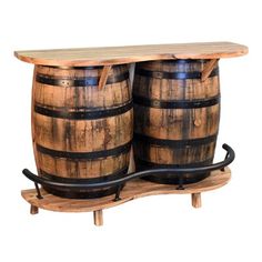 two wooden barrels sitting next to each other on top of a shelf with metal bars