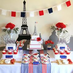 the dessert table is decorated with red, white and blue decorations for an eiffel tower themed party