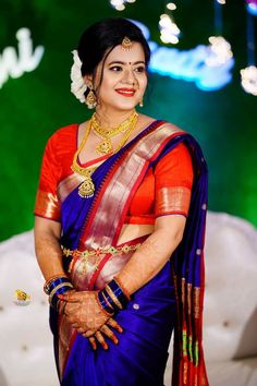 a woman in a blue and red sari