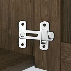 a close up of a door handle on a wooden cabinet