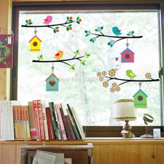 the window is decorated with colorful birds and birdhouses