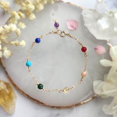 ✨ Seven Chakra Gemstone Bracelet with 14K Gold Filled, Rose Gold Filled, Sterling Silver Delicate Layering Bracelet, Rainbow Stone Bracelet ✨• Handmade in your preferred size with genuine gemstone beads. All metal parts are made with 14K Gold Filled, Rose Gold Filled, or 925 Sterling Silver.• Gemstone size: 4 mm• Seven gemstones representing the 7 energy points in your body or "chakra". It is well believed in the spiritual world that keeping these 7 points well-balanced is the key to a healthy b Dainty Gemstone 14k Gold Filled Bracelets, 14k Gold-filled Yellow Gold Bracelets With Birthstone, 14k Gold Filled Yellow Gold Bracelets With Birthstone, 14k Yellow Gold Filled Birthstone Bracelets, Adjustable Gold Multi-stone Bracelet, Gold Multi-stone Bracelets For Gifts, Spiritual Multi-stone Bracelets For Gift, Dainty Yellow Gold Bracelets With Gemstone Beads, Dainty Yellow Gold Bracelet With Gemstone Beads