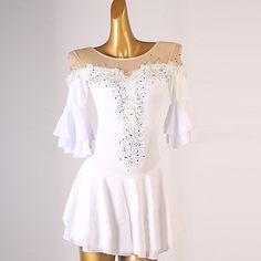 a woman's white dress on a mannequin headdress with sequins