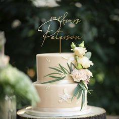 a wedding cake sitting on top of a wooden table