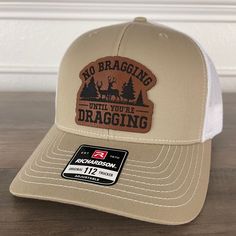 Join the ranks of hunters who understand the art of subtlety. Order your "No Bragging Until You're Dragging" Leather Patch Hat now and wear your love for the hunt! 🦌🧢 Specifications: 🧢 Richardson original 112 trucker; adjustable for the perfect fit 🎩 60/40 cotton/polyester blend for comfort 📏 One size fits most 🏷️ Expertly laser engraved leatherette patch design 📦 Ships in 2 to 3 business days from our Orlando Studio Care Instructions: 🚫 Do not wash; spot clean only Please Note: 🌈 Color Hat Patch Ideas For Men, Leather Patch Ideas, Leather Patch Hat Ideas, Orlando Studios, Funny Trucker Hat, Hat Bar, Leather Patch Hat, Engraving Ideas, Laser Design