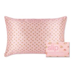 a pink pillow with flowers on it next to a box of lipp lipsticks