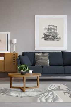 a living room filled with furniture and a painting on the wall above it's coffee table