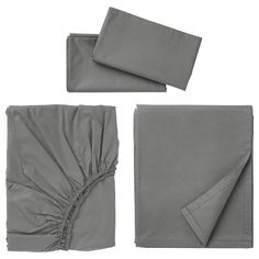 four pieces of gray bedding with ruffles on the bottom, and two sheets folded