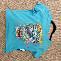 Brand New Urban Decay Ed Hardy Crop Top From July 2023. Originally $45.00. Significant Discount And Great Quality. Blue Graphic Print Crop Top T-shirt, Blue Y2k Crop Top For Streetwear, Blue Y2k Crop Top, Blue Graphic Crop Top T-shirt, Blue Graphic Tee Crop Top, Blue Y2k Short Sleeve Top, Blue Y2k Style Short Sleeve Top, Y2k Blue Short Sleeve Top, Y2k Short Sleeve Blue Top