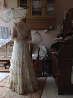 "Beautiful wedding dress with train Made of cream white/beige cotton full of embroidered flowers and a huge amount of valenciennes lace There are pin tucks on the sleeves and lace ruffles The front has an ornament made of pink ribbons with roses the front has some oxygen spots on the left shoulder ( see detail photo) the hemline of the dress has a bit discoloration. There are no other issues, this dress is strong and in excellent condition bust 92 cm 36\" waist 62 cm 24,5\" total length of the f Beige Victorian Wedding Dress With Ruffles, Cream Victorian Marie Antoinette Wedding Dress, Regency Victorian Dress With Ruffles In Cream, Victorian Lace Wedding Dress In Marie Antoinette Style, Lace Victorian Dress With Ruffles For Wedding, Vintage Victorian Dress With Lace For Wedding, Cream Regency Victorian Dress For Vintage Events, Historical Lace Trim Dress For Wedding, Cream Regency Style Victorian Dress For Vintage Events