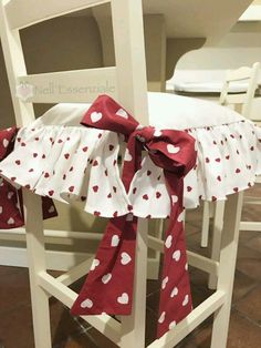 red and white polka dot chair sashes with hearts on them, tied to the back of chairs