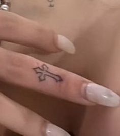 a person with a small tattoo on their finger