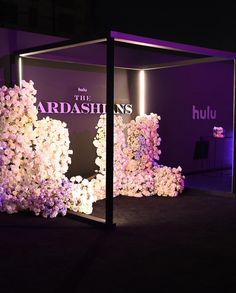 the display is decorated with flowers and purple lighting