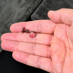 Product Details Hypoallergenic jewelry for sensitive skin.Holiday Peppermint Candy Stud Earrings These earrings for pierced ears will have you looking absolutely delicious! They're made with stainless steel straight posts with friction backs for a secure fit. They each feature a peppermint candy charm, inlaid in traditional red and white swirls for a truly tasty look. Get a fresh new look for the holidays with these sweet and sexy stud earrings! Sold as a set of two. Specifications: Approximatel Surgical Steel Drop Earrings For Gift, Surgical Steel Drop Earrings As Gift, Hypoallergenic Drop Plug Earrings For Gift, Nickel Free Minimalist Plug Earrings As Gift, Silver Surgical Steel Plug Earrings As Gift, Minimalist Surgical Steel Earrings As Gift, Adjustable Internally Threaded Plug Earrings As Gift, Silver Surgical Steel Plug Earrings For Gift, Nickel-free Stainless Steel Earrings Gift