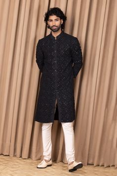 Black straight kurta with floral jaal embroidery on the front and sleeves. Comes with an ivory churidar.
Component: 2
Pattern: Embroidered
Type Of Work: Floral Jaal Patterns
Neckline: Mandarin Collar
Sleeve Type: Straight Long
Fabric: Cotton and Silk
Color: Green
Other Details: 
Front button down
Note: Pant worn by the model is not for sale
Occasion: Mehendi and Puja - Aza Fashions Resham Embroidery Bandhgala Straight Kurta, Embroidered Long Sleeve Churidar For Reception, Formal Traditional Wear With Mirror Work Straight Kurta, Chanderi Sherwani Straight Kurta For Reception, Semi-stitched Chikankari Kurta For Reception, Formal Straight Kurta With Mirror Work, Chanderi Sherwani For Reception, Festive Unstitched Suit With Dori Work And Long Sleeve, Eid Reception Kurta With Dori Work