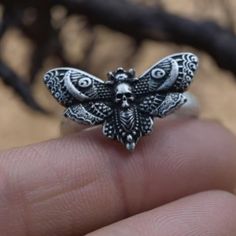 💀 Embrace Dark Elegance with the Skeleton Moth Ring 💀 Looking for a piece that combines mystery, edge, and timeless craftsmanship? This Skeleton Moth Ring is more than just jewelry--it's a statement of individuality. Handcrafted from solid S925 sterling silver, this unique punk Gothic biker ring blends vintage charm with a rebellious spirit, making it a perfect addition to any alternative fashion collection. Whether you're seeking a bold piece for yourself or a meaningful gift for someone spec Moth Ring, Dark Elegance, Biker Rings, Symbolic Jewelry, Vintage Style Jewellery, Memorial Jewelry, Men's Ring, Ring Vintage, Ring Handmade