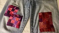 two patchwork jeans with different colors and patterns on them, one has a pocket in the back