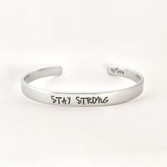 Christmas ordering deadline is Tuesday, December 15. STAY STRONGThis inspirational hand stamped cuff bracelet makes the perfect gift to give or treat for yourself. The cuff is 1/4 inch by 6 inches and is bent to fit most wrists. My items are hand stamped by me, making them a unique gift. Each letter is stamped individually and may not line up exactly adding to the charm and uniqueness of the gift. Visit my shop to view all of my other items by clicking here: https://www.etsy.com/shop/GemsbyJohnn Personalized Inspirational Cuff Bracelet For Everyday, Everyday Inspirational Personalized Cuff Bracelet, Everyday Hand Stamped Name Bracelet, Adjustable Personalized Cuff Bracelet For Everyday, Inspirational Stamped Adjustable Cuff Bracelet, Personalized Everyday Meaningful Cuff Bracelet, Everyday Personalized Meaningful Cuff Bracelet, Inspirational Adjustable Stamped Cuff Bracelet, Inspirational Adjustable Cuff Bracelet For Personalized Gift