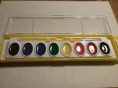 an assortment of different colored paints in a box