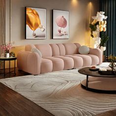 a living room with pink couches and white rugs on the hardwood flooring