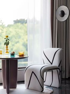 two chairs and a table in front of a window